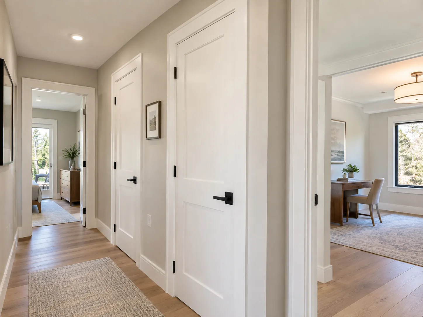 Updated hallway with white shaker interior doors and black hardware