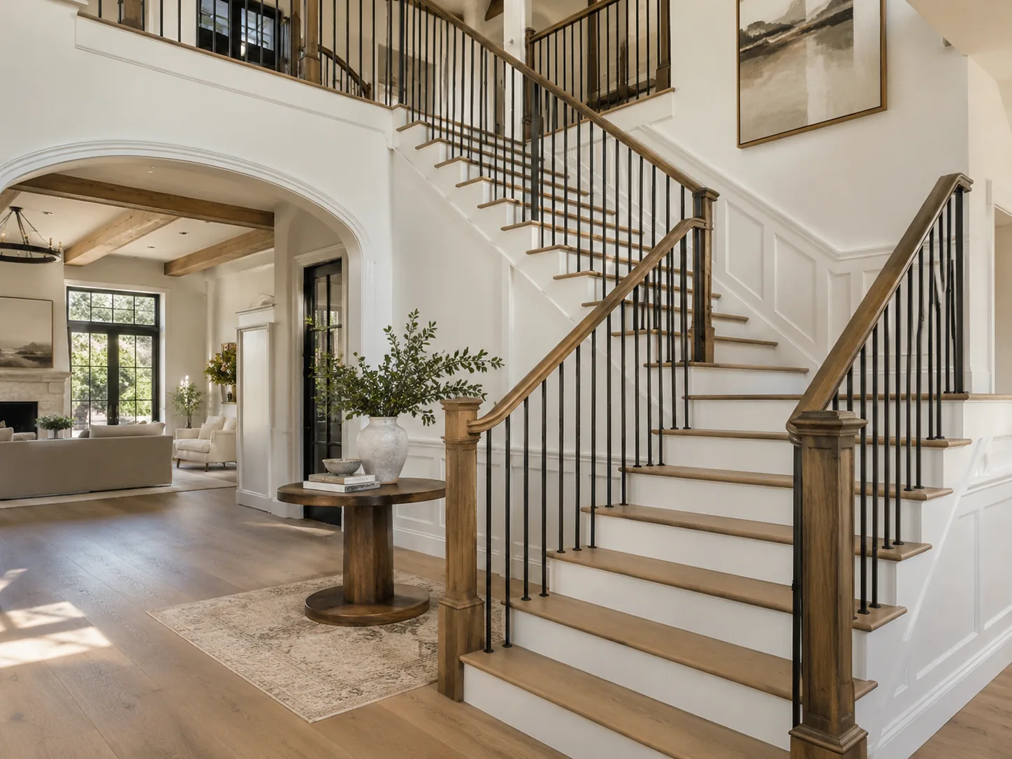 Staircase remodel with wood treads and black railings
